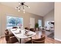 Inviting dining area with ample natural light and modern chandelier open to living space at 19481 E Milan Cir, Aurora, CO 80013
