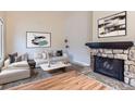 Bright living room with stone fireplace, wood floors, and modern decor creating an inviting space at 19481 E Milan Cir, Aurora, CO 80013