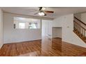 Bright living room featuring hardwood floors, modern ceiling fan, and an open floor plan at 11149 Gaylord St, Northglenn, CO 80233