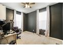 Bright home office features two windows, ceiling fan, and carpeted floor at 4343 S Nepal Ct, Centennial, CO 80015