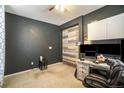 Home office with a built-in desk and barn door at 4343 S Nepal Ct, Centennial, CO 80015
