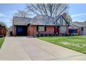 Charming brick home with attached garage and well-manicured lawn at 782 Holly St, Denver, CO 80220