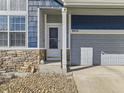 Charming two-story home boasts stone accents, a manicured lawn, and an attached two-car garage at 9832 Kenton Cir, Commerce City, CO 80022