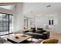 Bright living room with large windows, hardwood floors, and comfortable gray sofa at 12622 E Warren Dr # E, Aurora, CO 80014