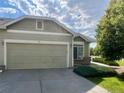 Attached two-car garage and driveway of a well maintained house in a residential neighborhood at 14400 Albrook Dr # 88, Denver, CO 80239