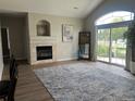 Bright living room with stone fireplace, high ceilings, and sliding glass doors to the backyard at 14400 Albrook Dr # 88, Denver, CO 80239