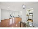 Bright living space with hardwood floors, French doors, and access to the kitchen at 1250 S Monaco Pkwy # 44, Denver, CO 80224