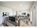 The open-concept living room features hardwood floors, recessed lighting, and a seamless flow to the kitchen at 1250 S Monaco Pkwy # 44, Denver, CO 80224