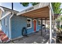 Exterior shot showing address, red door, and covered patio with a barbecue grill at 3151 N Elizabeth St, Denver, CO 80205