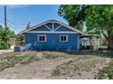 Rear view of the blue brick home showing the roof, and windows on a sunny day at 3151 N Elizabeth St, Denver, CO 80205
