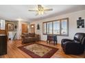 Inviting living room with hardwood floors, a ceiling fan, and lots of natural light at 1300 Kennedy Dr, Northglenn, CO 80234