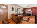 Comfortable living room featuring hardwood floors, a fireplace, and plenty of natural light at 1300 Kennedy Dr, Northglenn, CO 80234
