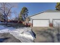 View of the home's front and two-car garage at 5222 S Emporia Way, Greenwood Village, CO 80111