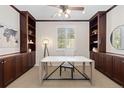 Well-appointed home office with built-in cabinetry, a bright window, and a modern desk creating an ideal workspace at 9450 Sori Ln, Highlands Ranch, CO 80126