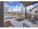 Inviting covered front porch with stylish seating, offering a relaxing outdoor space in a residential neighborhood at 1558 White Violet Way, Louisville, CO 80027