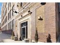 Exterior shot of brick warehouse loft building with street signage and the building entrance at 1863 Wazee St # 6E, Denver, CO 80202