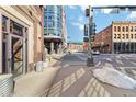 Exterior shot of brick warehouse loft building showing street entrance, and sidewalk view with traffic signal nearby at 1863 Wazee St # 6E, Denver, CO 80202