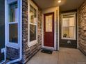 Charming entryway featuring a glass paneled red door, stone accents, and sidelight windows at 23545 E Platte Dr # C, Aurora, CO 80016