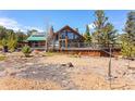 Stunning exterior showcasing a spacious deck and a wall of windows, perfect for enjoying the natural surroundings at 14800 Gold Hill Rd, Boulder, CO 80302