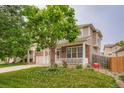 Inviting home exterior with brick accents, a cozy front porch, and a lush green lawn at 4426 Windmill Dr, Brighton, CO 80601