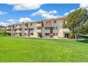 Spacious apartment complex with a well manicured lawn and multiple balconies at 10211 Ura Ln # 3-104, Thornton, CO 80260