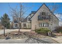 Charming home featuring mature trees, landscaped yard, and a cozy balcony at 7672 E Arizona Dr, Denver, CO 80231