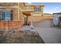 Brick two-story house with a two-car garage at 24758 E Arizona Cir, Aurora, CO 80018