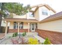 Inviting front porch with brick accents and a cozy seating area at 17722 E Ida Ave, Centennial, CO 80015
