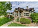 Inviting home exterior with manicured landscaping, brick accents, and a cozy front porch at 18324 E Bethany Pl, Aurora, CO 80013