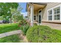 Beautifully landscaped front yard with lush greenery, flowering plants, and a welcoming walkway at 18324 E Bethany Pl, Aurora, CO 80013