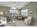 Bright living room with vaulted ceilings, shuttered windows, and neutral decor at 18324 E Bethany Pl, Aurora, CO 80013