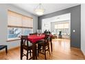 Dining room featuring hardwood floors, light gray accent walls, and access to living area at 1775 W 130Th Pl, Westminster, CO 80234