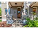 Inviting front porch with sturdy columns, a classic wooden door, and well-maintained steps leading to the entrance at 2566 N Emerson St, Denver, CO 80205