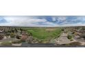 Panoramic aerial view showcasing the neighborhood, a golf course, and distant city skyline at 12391 E Cedar Cir, Aurora, CO 80012