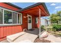 Inviting covered front porch with access ramp, showcasing a charming and accessible home entrance at 753 S Utica St, Denver, CO 80219