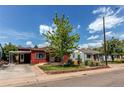 A charming red bungalow with a carport on a tree-lined street with classic curb appeal at 753 S Utica St, Denver, CO 80219