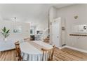 Bright dining room featuring wood floors, a large table with seating, and a staircase at 5102 S Lisbon Way, Centennial, CO 80015