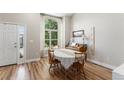 Inviting dining room with ample natural light, wood floors, and a piano at 5102 S Lisbon Way, Centennial, CO 80015