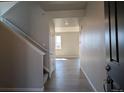 Bright entryway with hardwood floors, staircase, and white trim at 16815 Mckay Dr, Mead, CO 80542