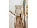 Inviting entryway with wood floors, white walls, and decorative gold artwork at 9503 Richfield St, Commerce City, CO 80022