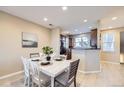 Well-lit dining room features an adjacent kitchen, perfect for easy entertaining at 8915 Federal Blvd # 203, Denver, CO 80260