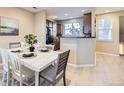 Bright dining area with wood floors and ample seating space near the kitchen at 8915 Federal Blvd # 203, Westminster, CO 80260