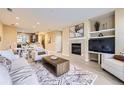 Bright living room featuring a fireplace, plush rug, and open floor plan at 8915 Federal Blvd # 203, Westminster, CO 80260