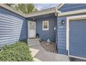 Inviting entrance showcasing blue siding, a well-manicured yard, and a charming walkway leading to the front door at 5016 S Nelson St # C, Littleton, CO 80127