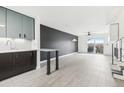 Open concept kitchen and living room with modern light fixture, staircase, and sliding glass doors to patio at 5711 W 92Nd Ave # 25, Westminster, CO 80031
