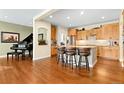 Open concept kitchen with wood floors, a large island, and seamless transition to the living spaces at 507 Ulster Way, Denver, CO 80230