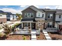 Inviting townhome featuring a front porch seating area and beautifully landscaped front yard at 1500 Sun Way, Lafayette, CO 80026