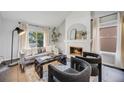 Bright living room with fireplace, neutral decor, and large windows that let in lots of natural light at 3889 S Fraser St, Aurora, CO 80014
