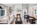 Bright living room featuring a decorative fireplace, plush seating, and elegant decor at 3889 S Fraser St, Aurora, CO 80014