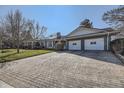 Beautiful home featuring a spacious driveway, well-maintained lawn, and a two-car garage at 4401 S Yosemite Ct, Greenwood Village, CO 80111